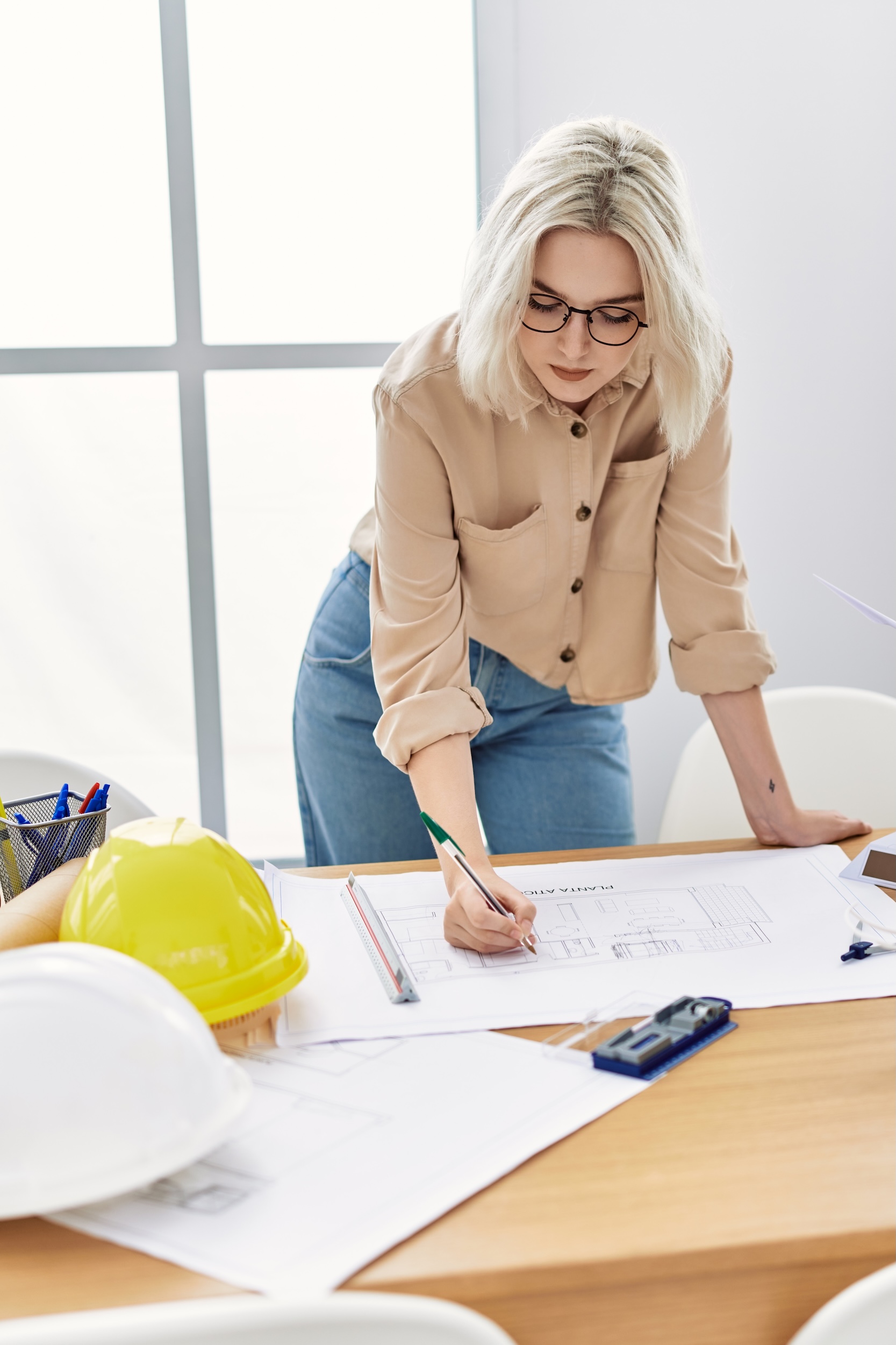 Young caucasian woman working at architect studio